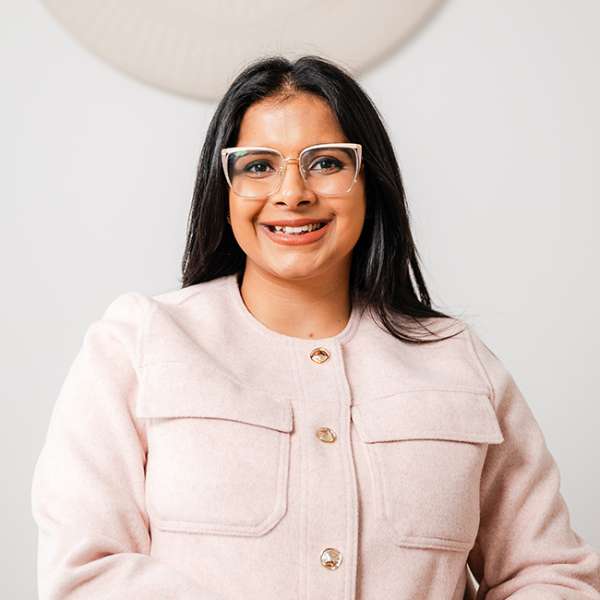 DR. ANJUMAN BAINS Woman with Black hair sitting.